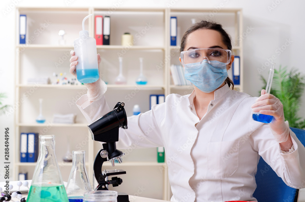 Young female chemist working in the lab Young female chemist working in the lab