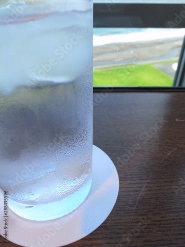 glass of water on background of blue sky and clouds