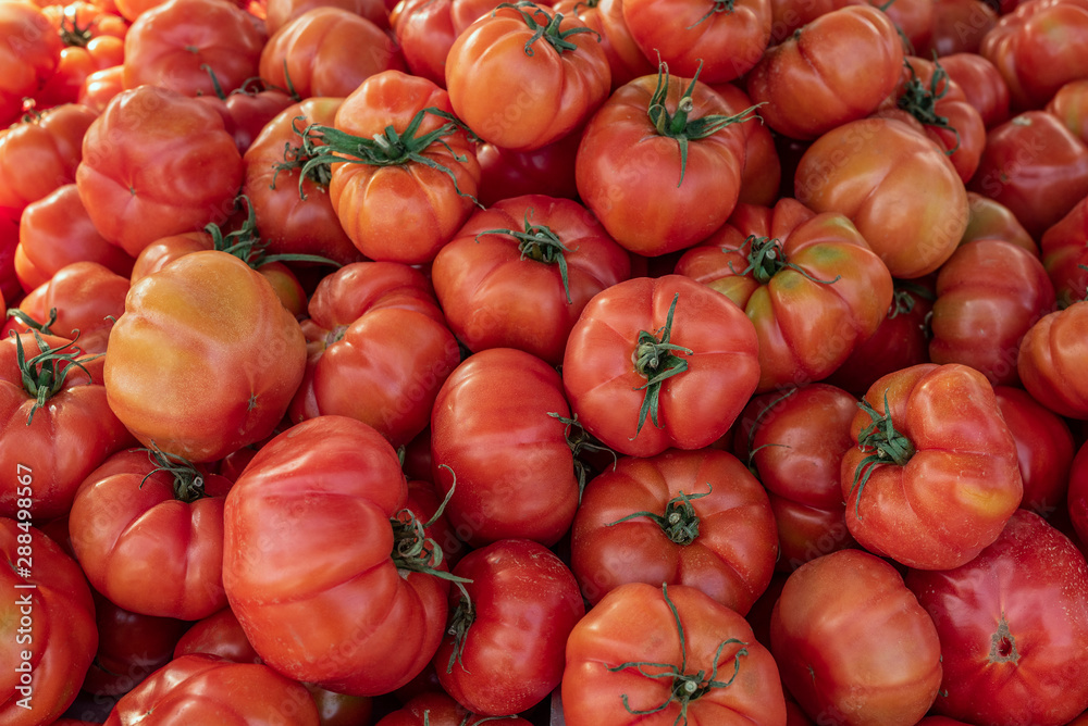 Close up view of Ripe pink Raf tomato food background. Huge tomatoes on spanish weekly marketplace Close up view of Ripe pink Raf tomato food background. Huge tomatoes on spanish weekly marketplace