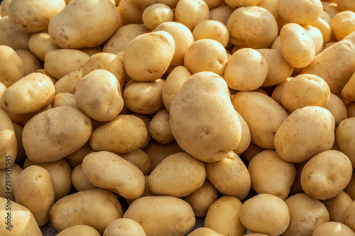 Food background of washed Organic potatoes on a market stall. Weekly spanish marketplace