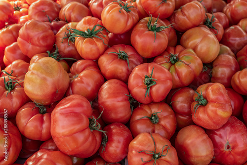 Close up view of Ripe pink Raf tomato food background. Huge tomatoes on spanish weekly marketplace