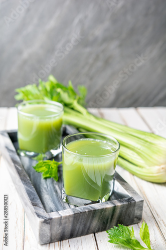 Freshly made pure celery juice in glass jars with copy space