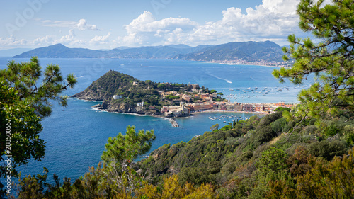 Fototapeta Naklejka Na Ścianę i Meble -  Sestri Ponente, Genoa, Italy. Baia del Silenzio panoramic view from above immersed in nature. In the background Ligurian mountains topped by white clouds