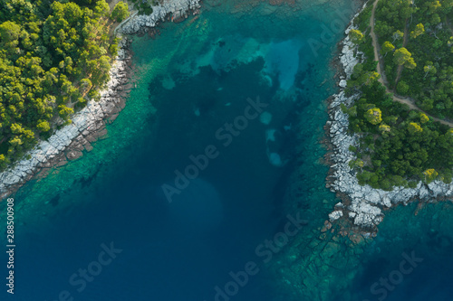 Aerial shot of waves crushing at cliffs and rocks at Brac, Croatia