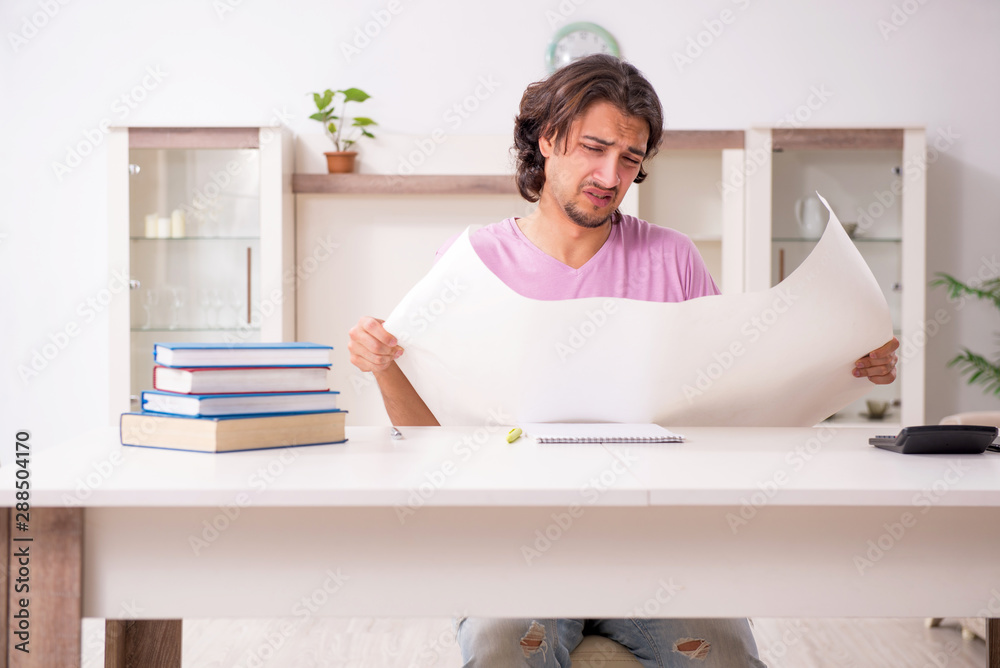 Young male architect student preparing for exams at home Young male architect student preparing for exams at home
