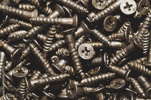 Screws background. heap of tapping screws. pile of fasteners