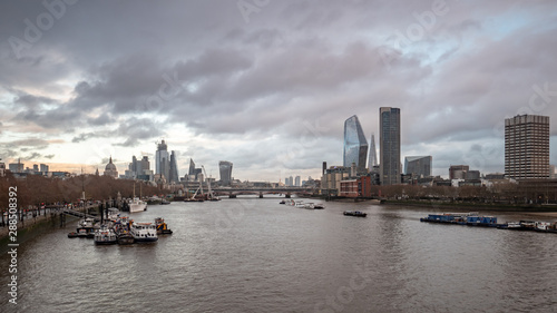 The London skyline on a grey and overcast winter s day looking east from Waterloo Bridge towards the skyscrapers of the financial district.