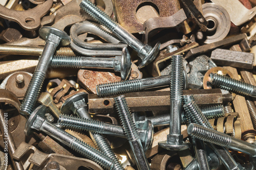 Screws background. heap of tapping screws. work tool. pile of fasteners. bolts and nuts. metal scrape