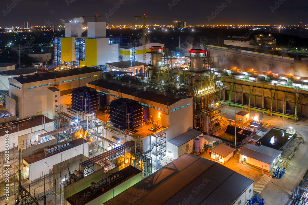 Aerial view of combined cycle power plant and cooling tower during operation with steam or plume