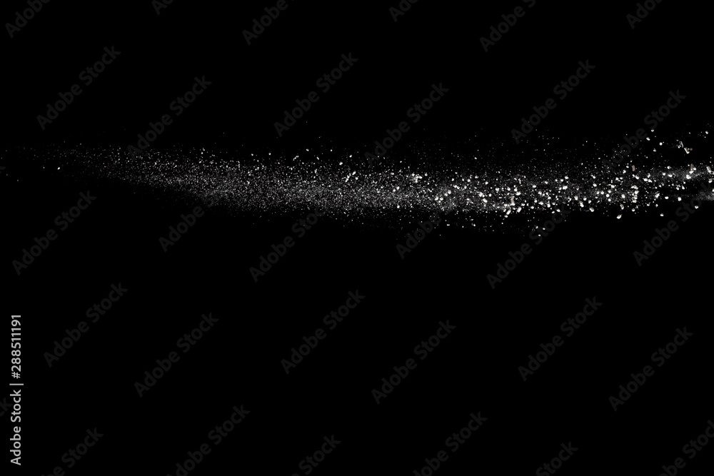Obraz premium Freeze motion of white dust particles on black background.