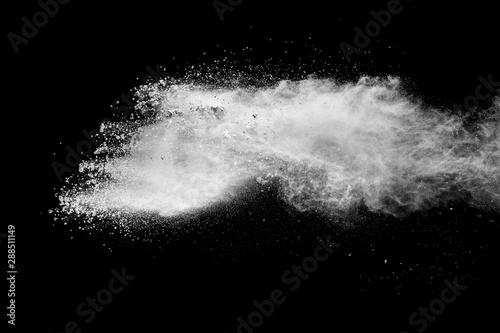 White powder explosion clouds.Freeze motion of white dust particles on black background.
