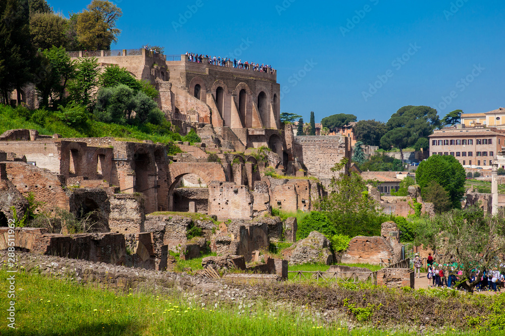 Tourists visiting the Domus Tiberiana and the Roman Forum in Rome