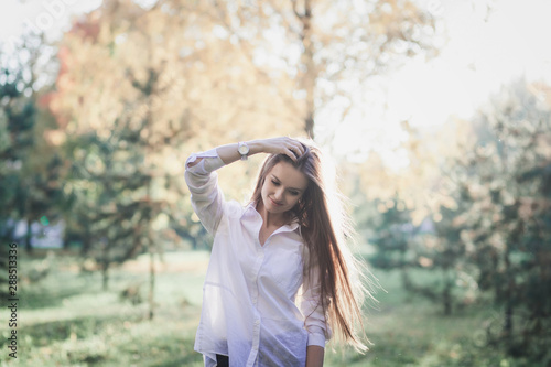 happy girl walks in autumn park at sunset