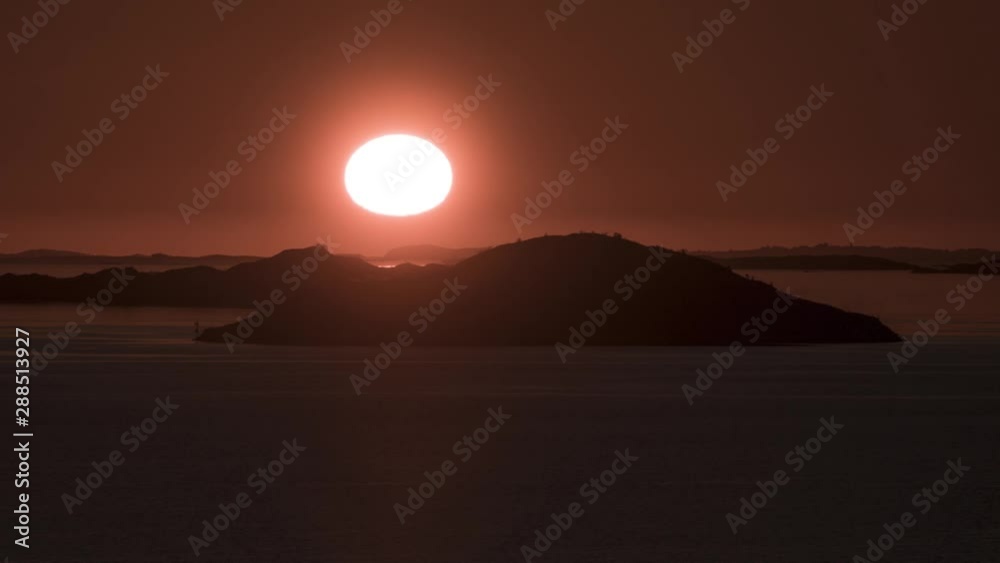 Time lapse of scenic sunset over hills, islands and ocean while zooming in Time lapse of scenic sunset over hills, islands and ocean while zooming in