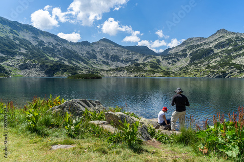Familly enjoying on the amazing scenery towards the Popovo lake and the peaks photo