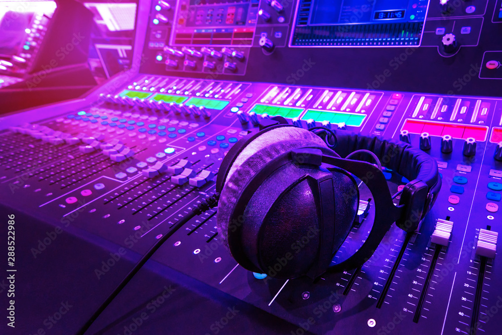 Professional audio studio sound mixer console board panel with recording ,  faders and adjusting knobs,TV equipment. Blue and red tone and close-up  image with flare light effect. Stock Photo | Adobe Stock