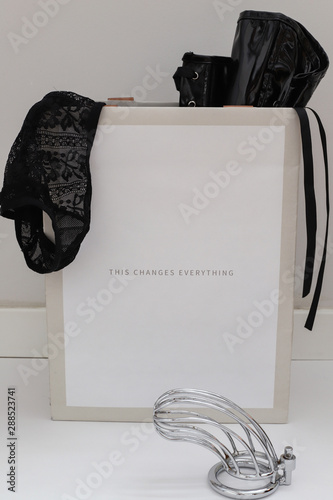 Fotografia sex shop commercial, package on white background with thong and chastity belt