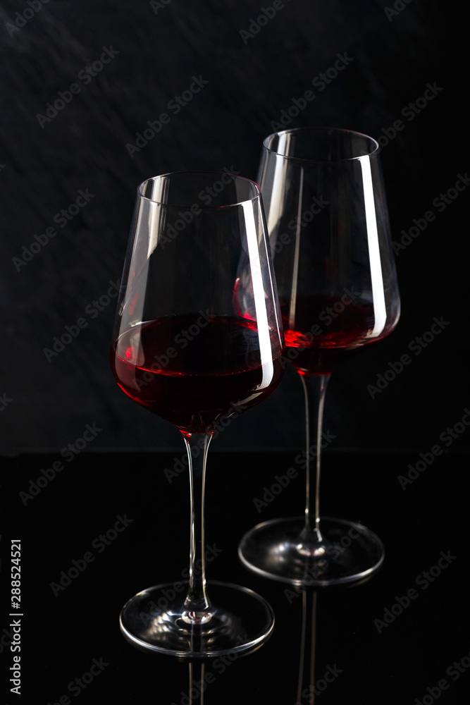 Bottle and glass of red wine on black background Bottle and glass of red wine on black background