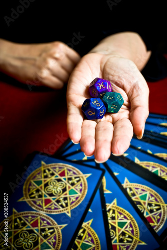 Obraz na płótnie astrologer fortune teller hand with astrology dice and tarot cards