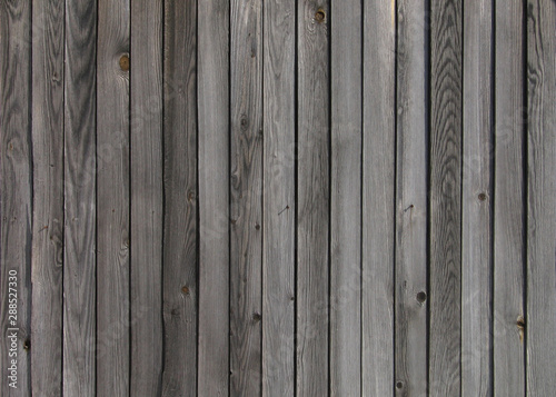 Old gray wooden wall with vertical aged planks. Abstract background