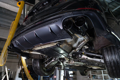 Wallpaper Mural Bottom view of the car on a bifurcated exhaust system, rear bumper with a sports diffuser and nozzles in black. Tuning and atom service industry. Torontodigital.ca