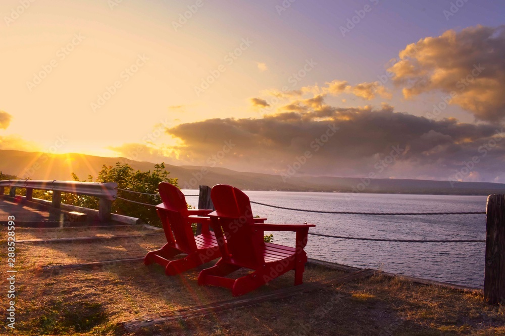 Two red chairs in sunset