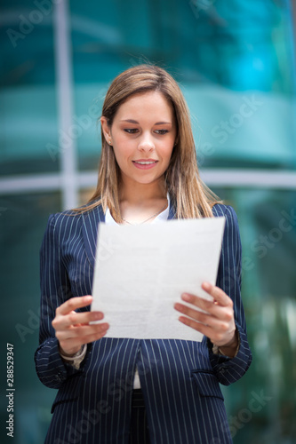 Businesswoman outdoor reading a document