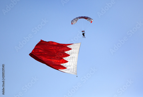 Parachute display team performs  during cricket festival at Isa Town, Bahrain photo