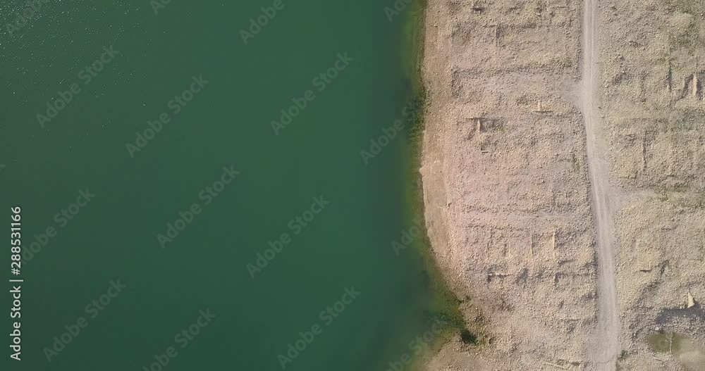 Overhead flight over the shore near sand road Overhead flight over the shore near sand road