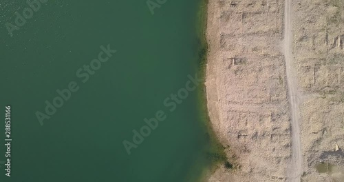 Overhead flight over the shore near sand road