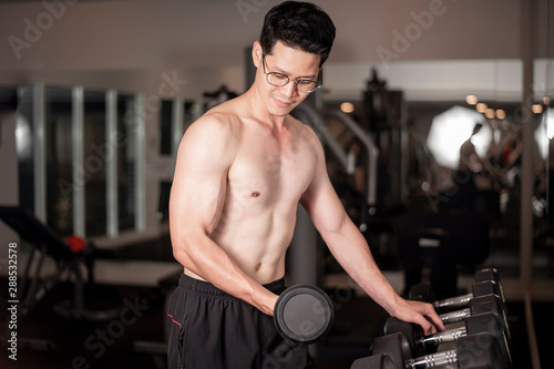 Asian man is working out in fitness gym
