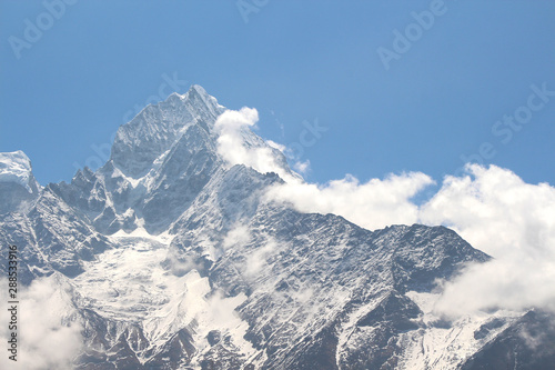 View of Kangtega Mountain peak covered with snow, ice and clouds from Khunde village in Sagarmatha national park in Nepal. Nature, outdoors. inspiration, motivation, travel and tourism concept.