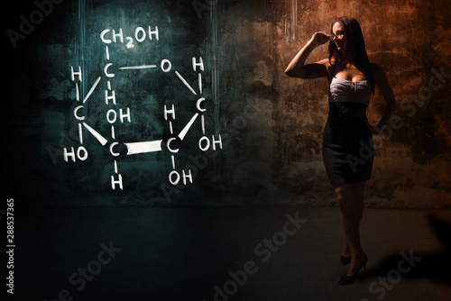 Sexy girl or secretary or female student presenting handdrawn chemical formula of glucose