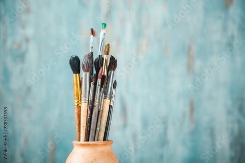 paint brushes on abstract blue background