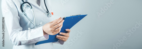 woman doctor hand documant on gray background photo