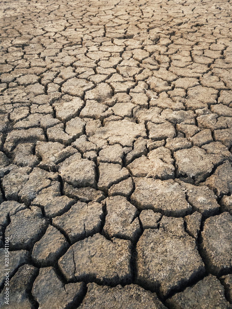 Dry and broken clay ground during drought season, concept of global warming problem. Cracked and barren soil texture background. The global shortage of water on the planet. Arid land, natural disaster Dry and broken clay ground during drought season, concept of global warming problem. Cracked and barren soil texture background. The global shortage of water on the planet. Arid land, natural disaster