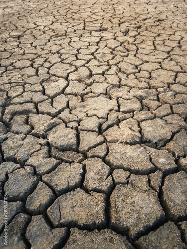Dry and broken clay ground during drought season, concept of global warming problem. Cracked and barren soil texture background. The global shortage of water on the planet. Arid land, natural disaster