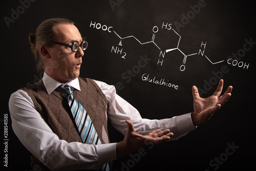 Professor presenting handdrawn chemical formula of Glutathione antioxidant peptide photo