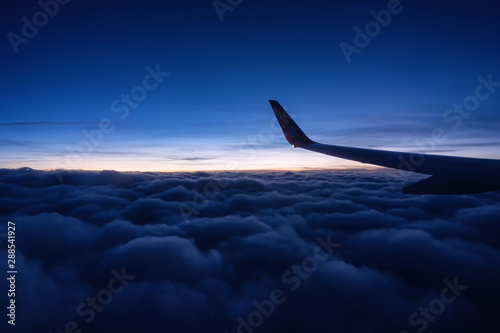 View outside the plane window.Beautiful sunset fly above cloud.
