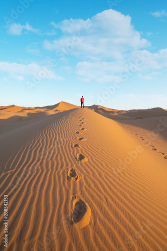 One person man in dune of Sahara in Morocco