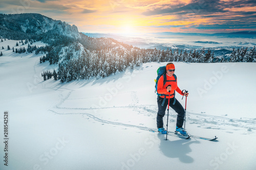 Ski touring on the snowy hills at sunset, Carpathians, Romania