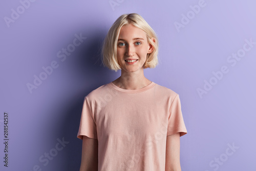 Fotografija close up portrait of attractive girl with green eyes in pink T-shirt looking at the camera, people concept