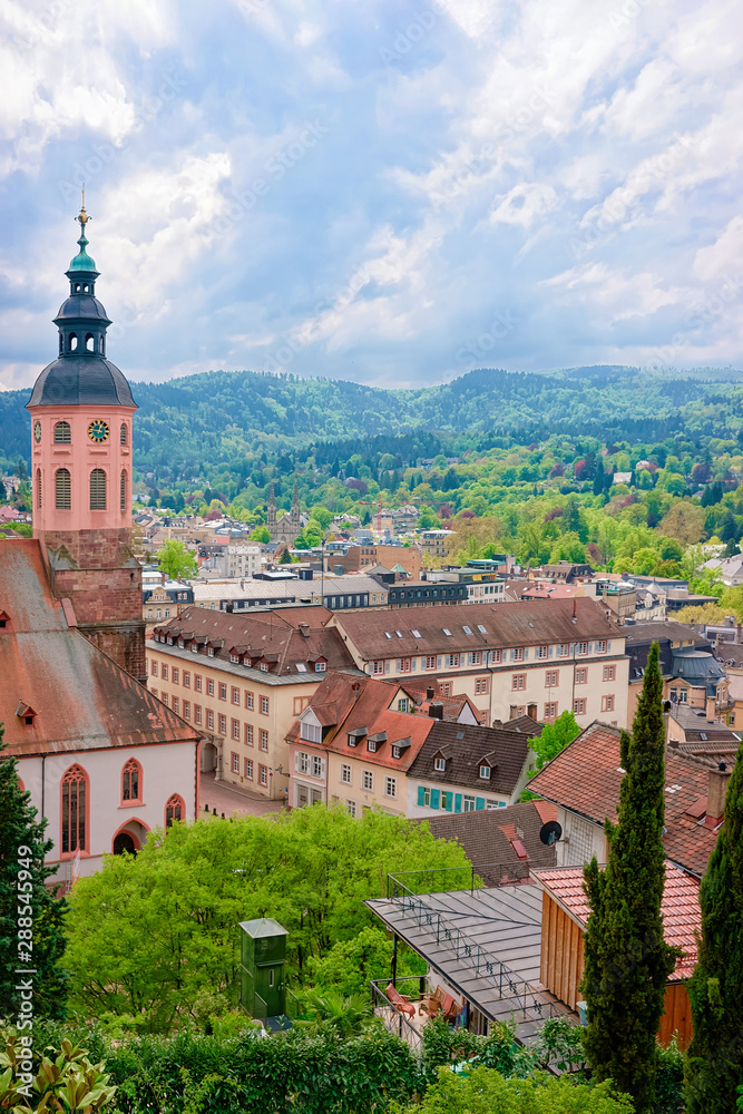 Collegiate church Stiftskirche and cityscape with Black forest in Old city in Baden Baden of Baden Wurttemberg region in Germany. View of Bath and spa German town in Europe. Landmark scenery