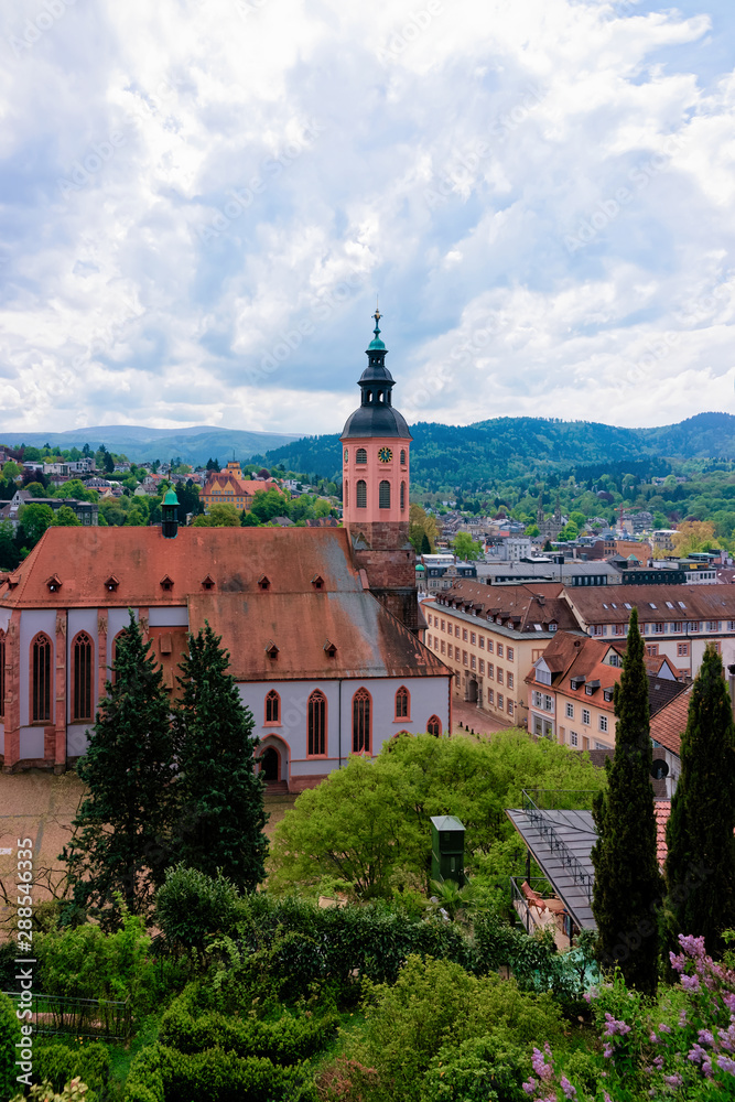 Stiftskirche Collegiate church and cityscape with Black forest of Old city of Baden Baden in Baden Wurttemberg region in Germany. View of Bath and spa German town in Europe. Landmark scenery