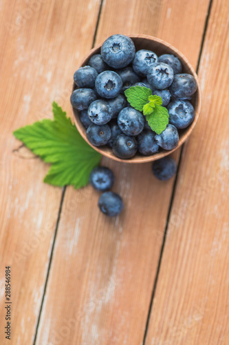 Fresh and natural blueberry with mint on a wooden table