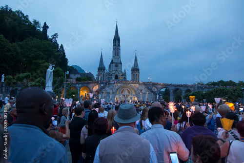 Lourdes, France, 24 June 2019: Evening procession with candles at the shrine of Lourdes photo