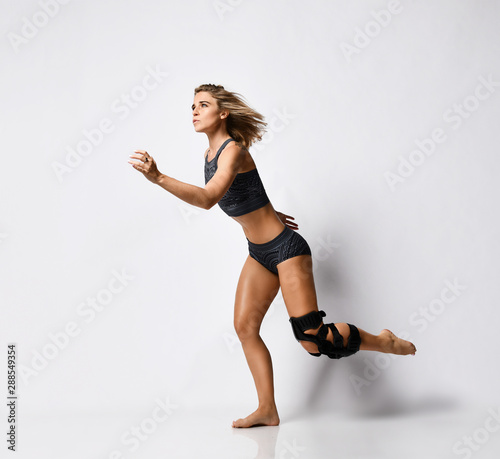 Woman with knee brace. Isolated. photo