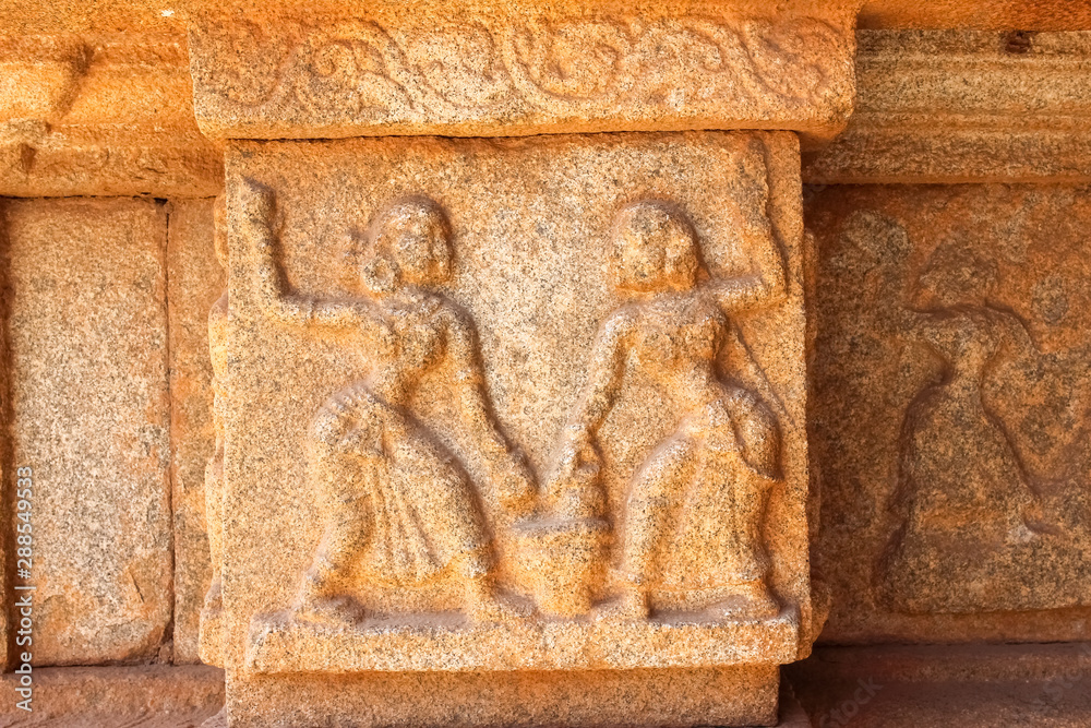 stone carving of female dancing duo in the ancient ruins of hampi