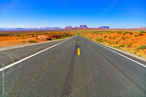 View of Monument Valley on a sunny day near the border of Arizona and Utah in Navajo Nation Reservation in USA.