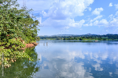 Sunset view of the Victoria Nile river, with trees growing and the reflections on the water, Jinja, Uganda, Africa photo